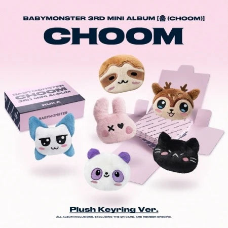 Plush keyrings and album packaging with 'Babymonster' branding on a pink background
