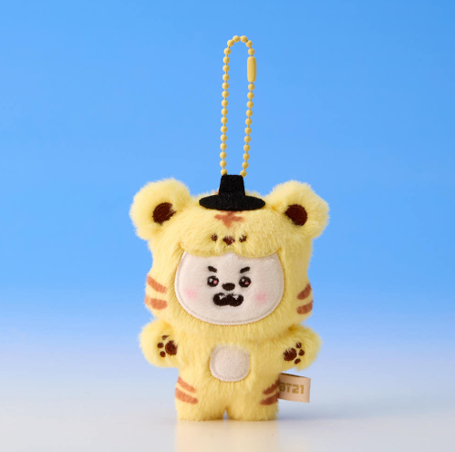 Plush keychain in bear costume with black face on a blue background