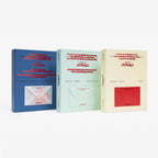 Three books with different colored covers on a white background