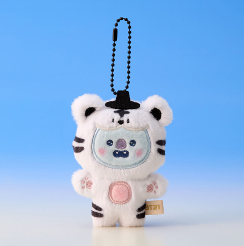 Plush keychain of a white tiger with black stripes on a blue background