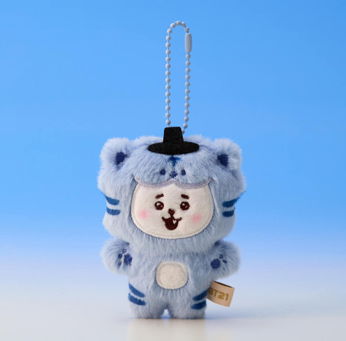 Plush keychain with a character wearing a blue outfit and black hat on a blue background